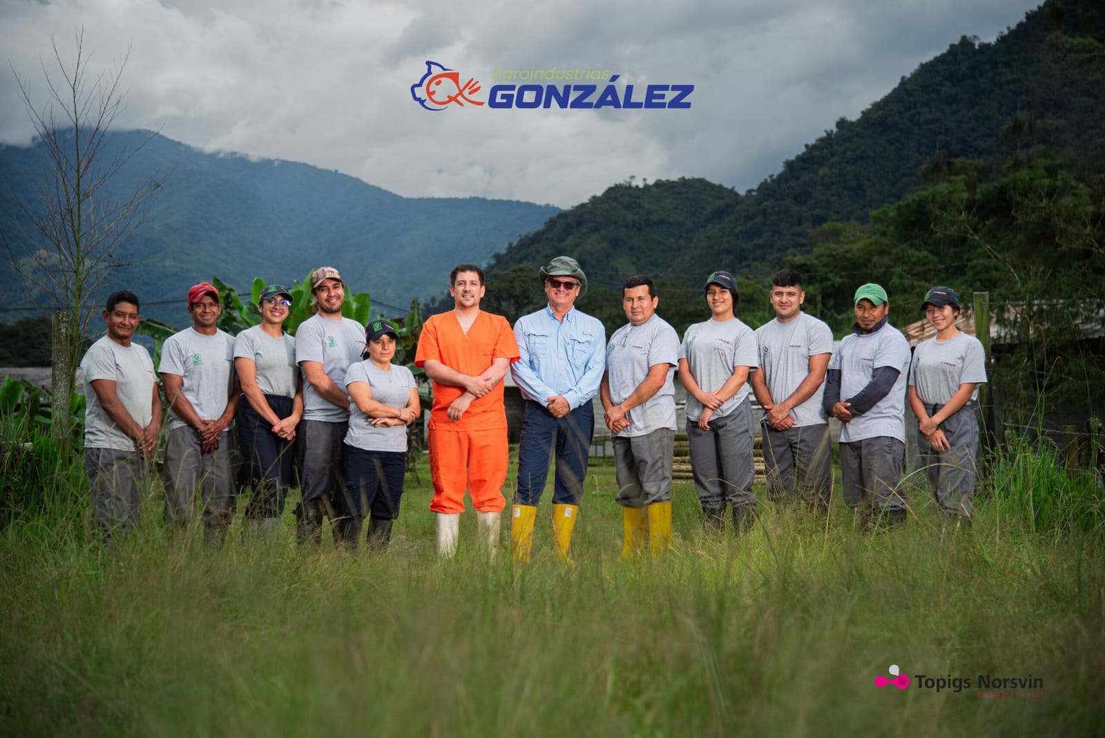 El equipo del grupo reunido en un potrero, con las montañas amazónicas al fondo